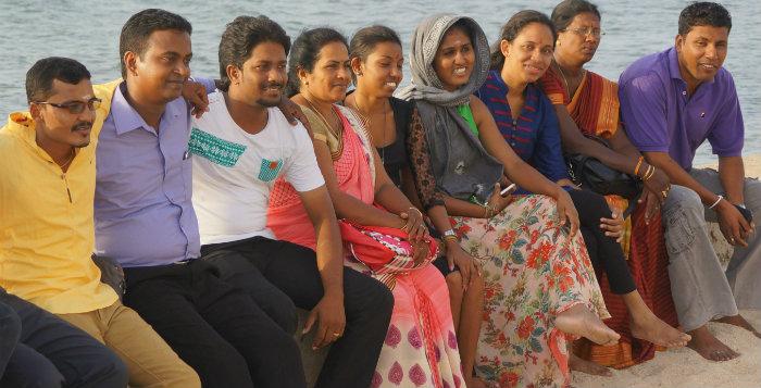 Group of young people sitting next to each other