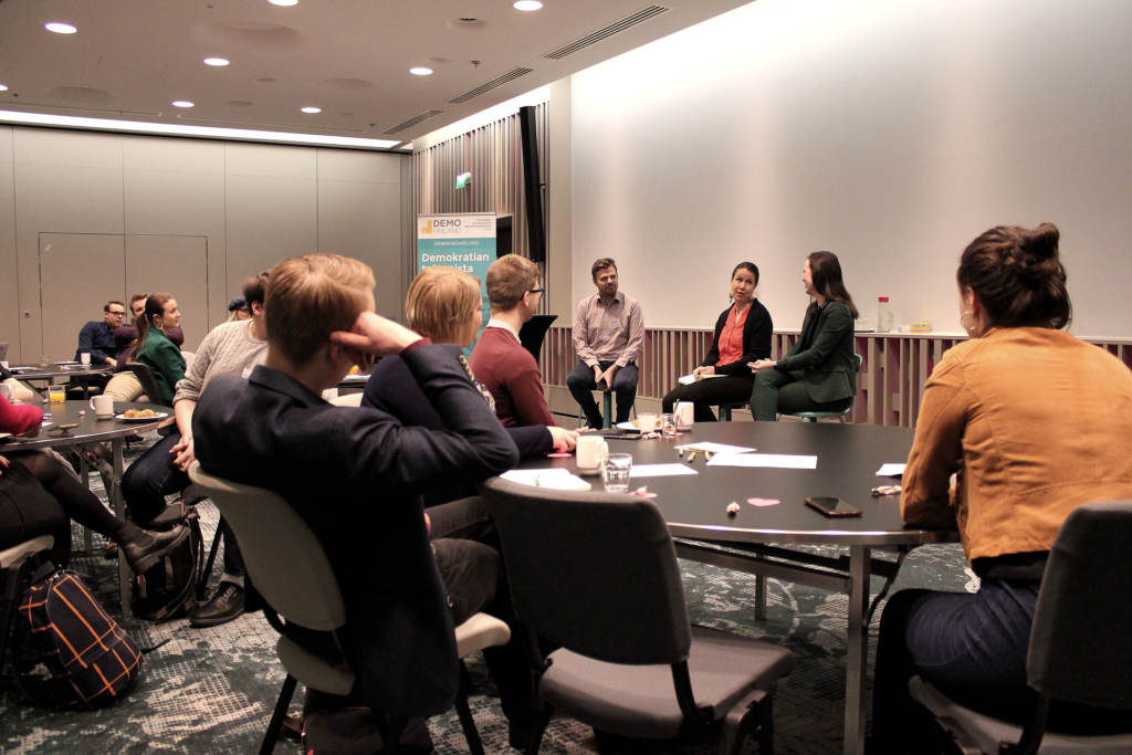 Group of people listening to a panel discussion