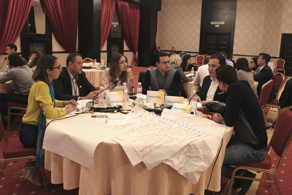 Young Tunisian politicians sitting around a table