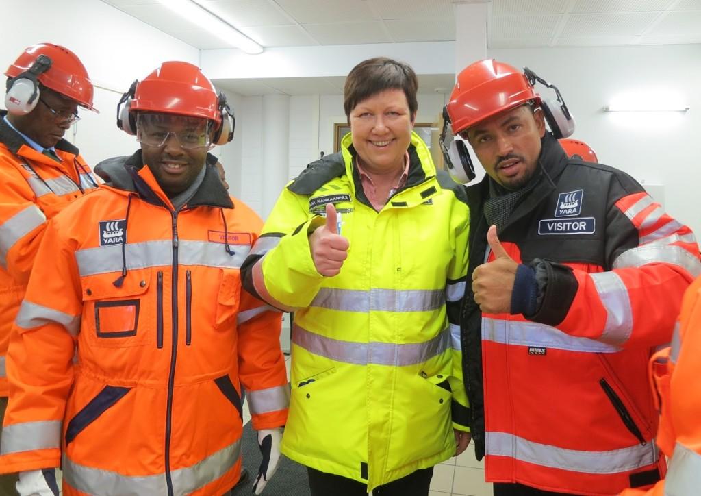 Three people with protective gear pose to the camera