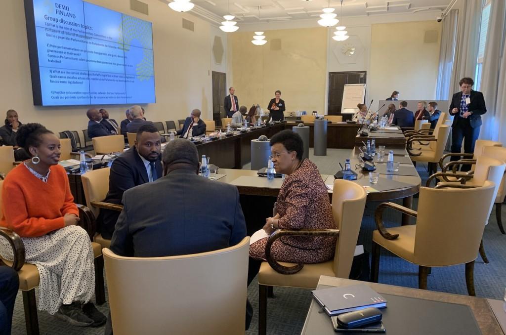 MPs Bella Forsgrén and Suldaan Said Ahmed discussing with two Mozambican MPs, with other discussion groups in the background