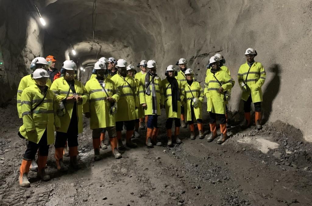 Group of people in a protective gear inside a mine