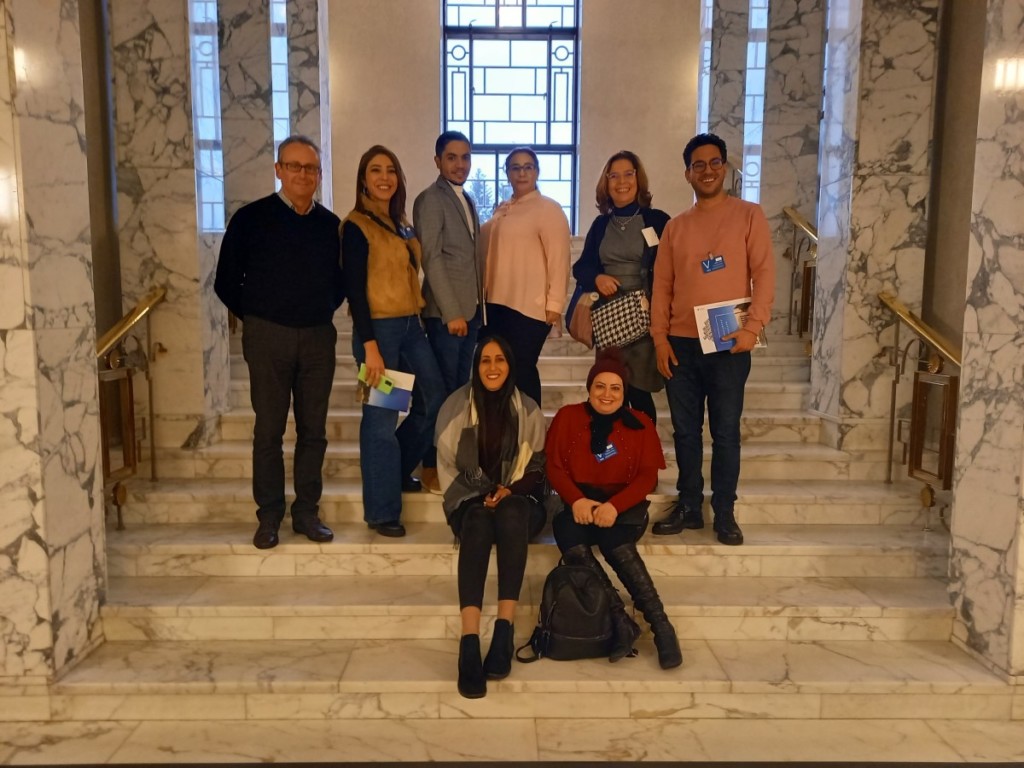 Group of Tunisians standing on stairs inside the Finnish Parliament