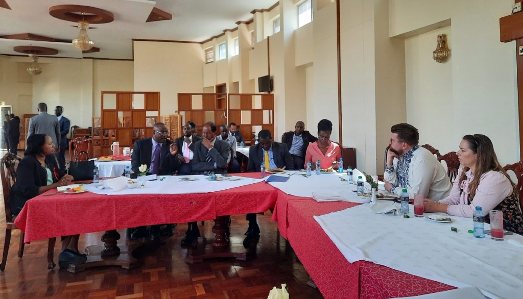 Finnish and Kenyan people sitting behind a long table