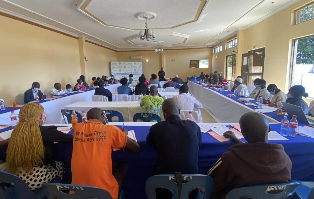 People in a training room listening to a man speaking in front of the room.