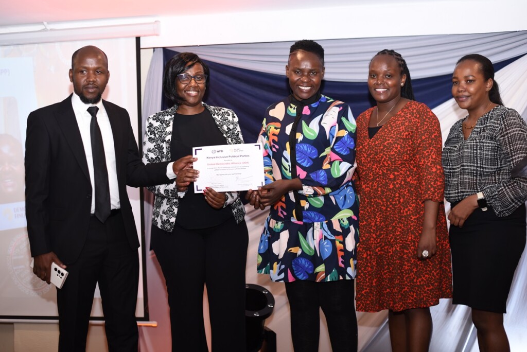 Five Kenyan people smiling at the camera and showing a certificate